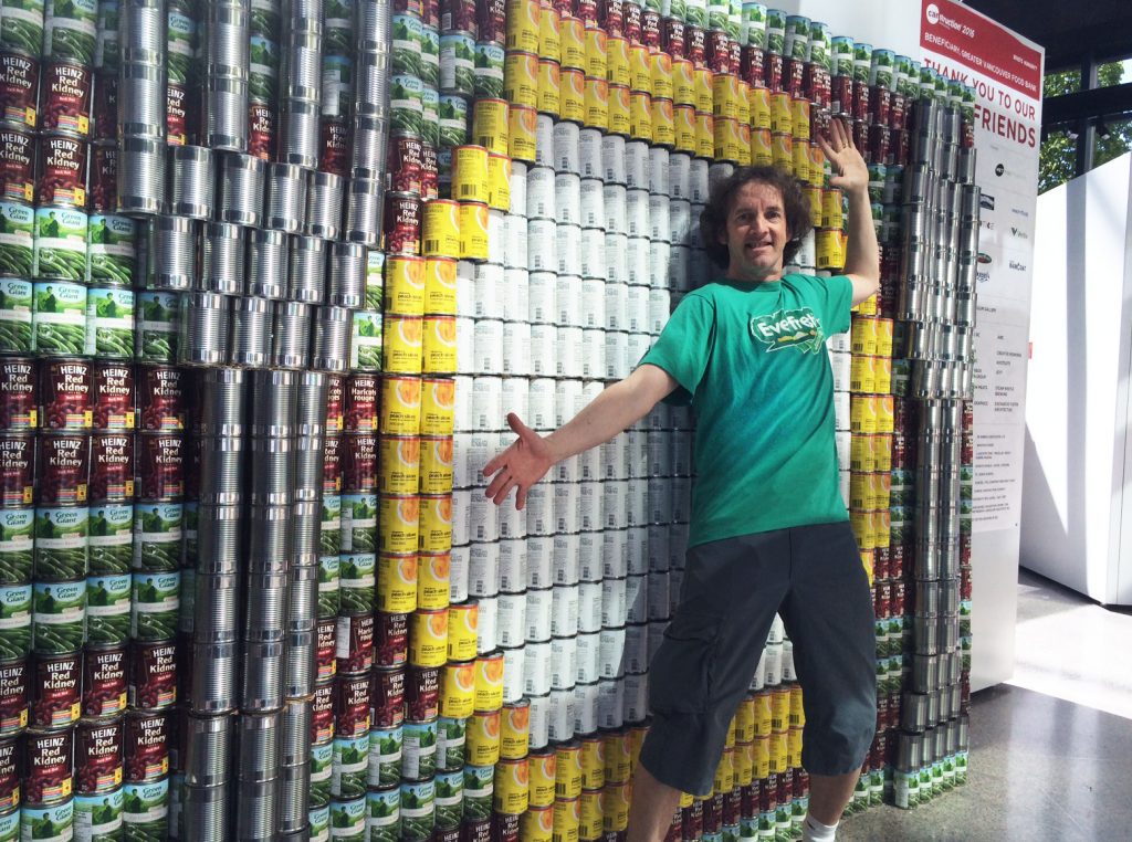 Unicycle Creative Lorne Craig poses with Canstruction sculpture